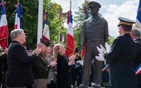 From left, Mark Milley, retired general and former chairman of the Joint Chiefs of Staff, NATO supreme allied commander in Europe Gen. Christoper Cavoli and Susan Eisenhower help unveil a statue of Dwight D. Eisenhower in Sainte-Mère-Église, France, Monday, June 3, 2024.