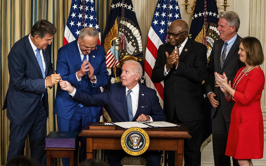 President Biden hands Sen. Joe Manchin III, D-W.Va., the pen used to sign into law the Inflation Reduction Act at the White House on Aug. 16, 2022. 