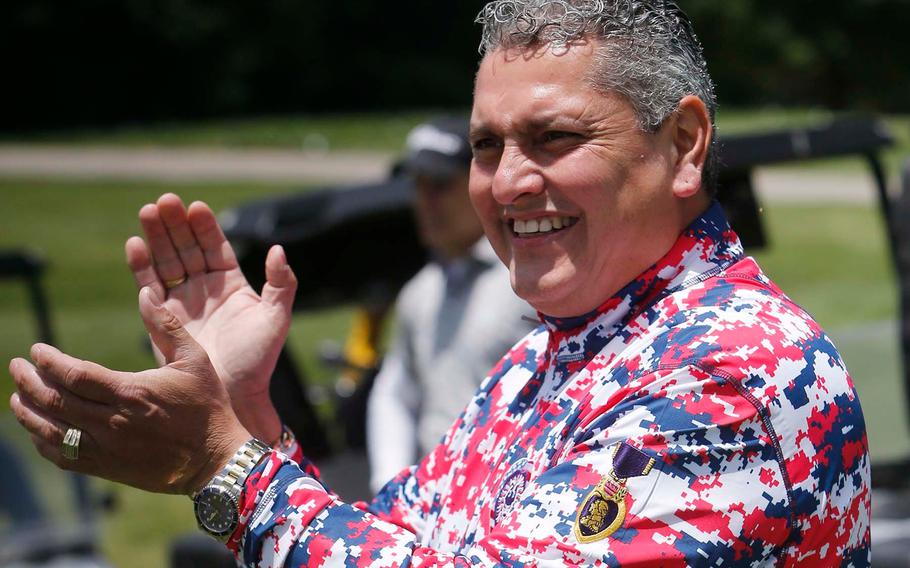 Major Ed Pulido, the founder and CEO of the John Daly-Major Ed Heart of a Lion Foundation, applauds golfers as they tee off on 17 on the North Course at Firestone Country Club Tuesday, June 22, 2021 in Akron, Ohio.