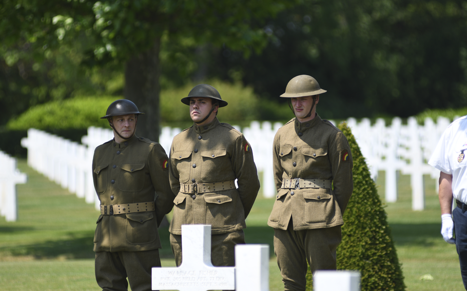 Three soldiers dress in World War I-era uniforms during the reinterment ceremony at the Oise-Aisne American Cemetery in Seringes-et-Nesles, France, on Wednesday, June 7, 2023.