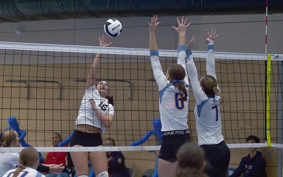 Stuttgart's Sara Houghton tries to hit the ball over Wiesbaden's Lorelei Kemmer and Audrey Garrison during pool-play action of the DODEA European volleyball championships on Oct. 26, 2023, at Ramstein High School on Ramstein Air Base, Germany.