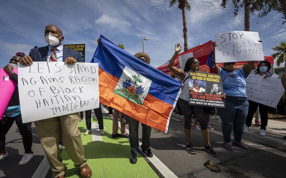 Protestors chant slogans in front of the USCIS district office in Miami as members of Miami’s Haitian community protest Sept. 22, 2021, against the Biden administration for their handling of Haitian immigrants at the U.S.-Mexico border.