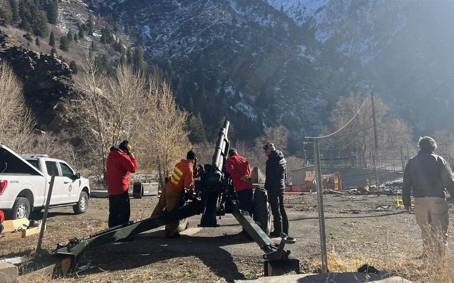 Utah Department of Transportation workers fire a howitzer during a training mission in Big Cottonwood Canyon in November 2022. Many Western state transportation officials use howitzers and remote devices to set off controlled avalanches to keep roads safe for drivers. 