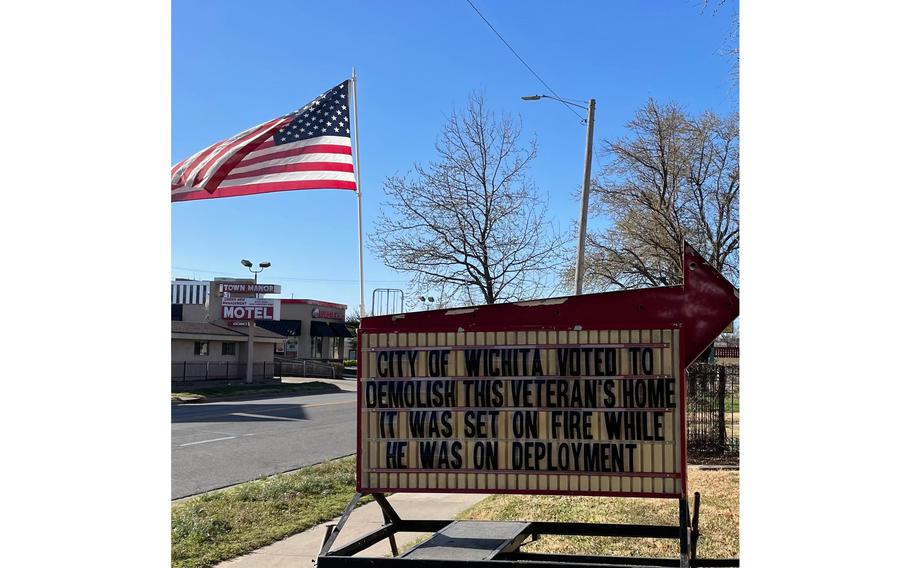 A sign in front of Kansas National Guardsman Don “Rhino” Lobmeyer’s home in Wichita, Kan., which caught fire in February 2019. The city of Wichita condemned the property, but a support system of veterans and volunteers is rallying behind the soldier in an effort to save his house from the bulldozers.