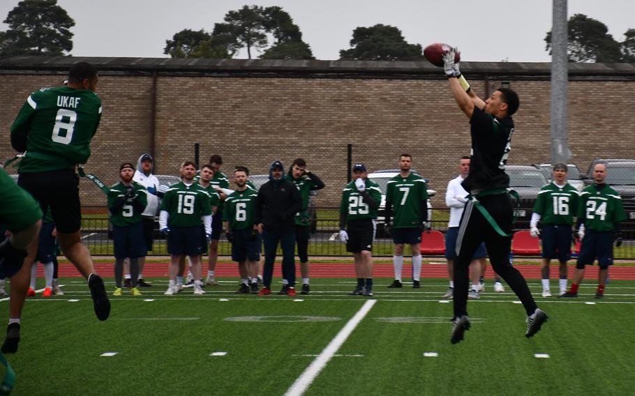 U.S. Air Forces Airman 1st Class Cody Alfred, from the 495th Aircraft Maintenance Unit, jumps up and snags the ball out of the air during a multi-service flag football game at RAF Lakenheath on Friday.