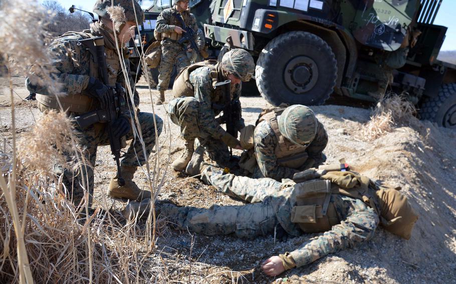 Marines prepare to evacuate a mock casualty during the Bushido Strike exercise at Dagmar North Training Area in Paju, South Korea, Tuesday, Feb. 21, 2023.