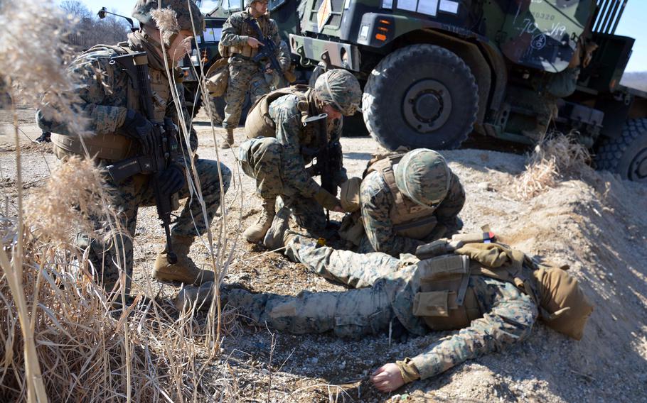 Marines prepare to evacuate a mock casualty during the Bushido Strike exercise at Dagmar North Training Area in Paju, South Korea, Tuesday, Feb. 21, 2023.