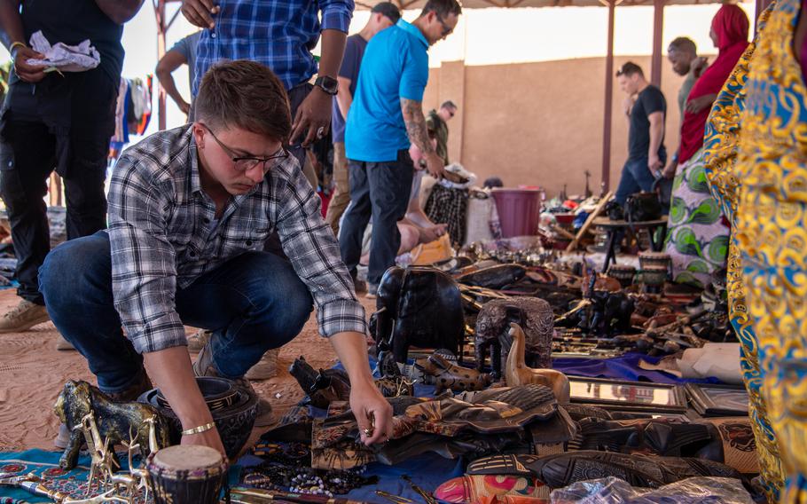 A U.S. service member browses handmade items Dec. 2, 2023, at the women’s bazaar at Base 201 in Agadez, Niger. The bazaar brought in $11,350 to support the local economy.