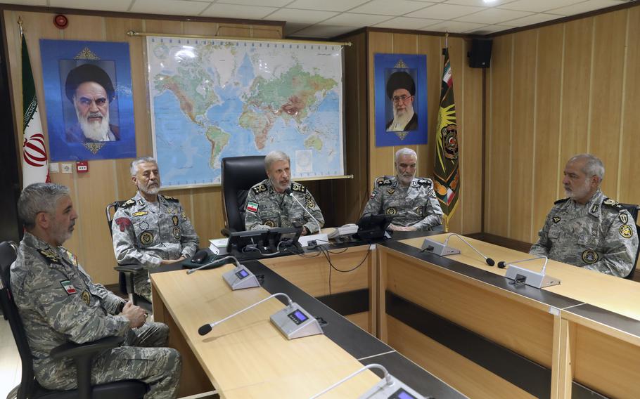 Military leaders speak in a conference room