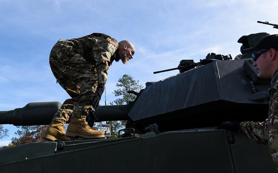 Jay Tenison, a former Army tanker who served in Iraq, enters an M1A2 Abrams tank at Fort Moore, Ga., on Dec. 5, 2023, before shooting the tank as his dying wish. Tenison was diagnosed in 2022 with terminal stomach cancer. 