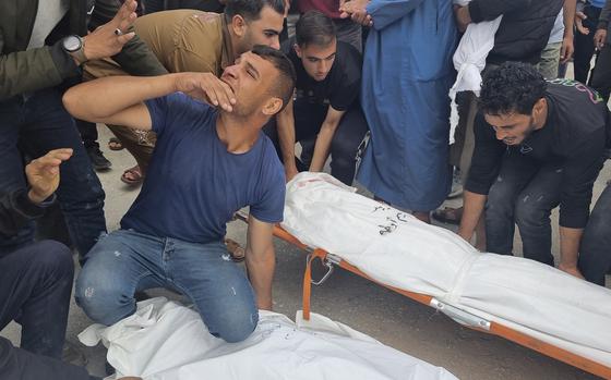 Mourners carry the bodies of members of the Abu Taha family, who were killed in an Israeli airstrike, during their funeral at Al-Salam cemetery in Gaza on April 29, 2024.