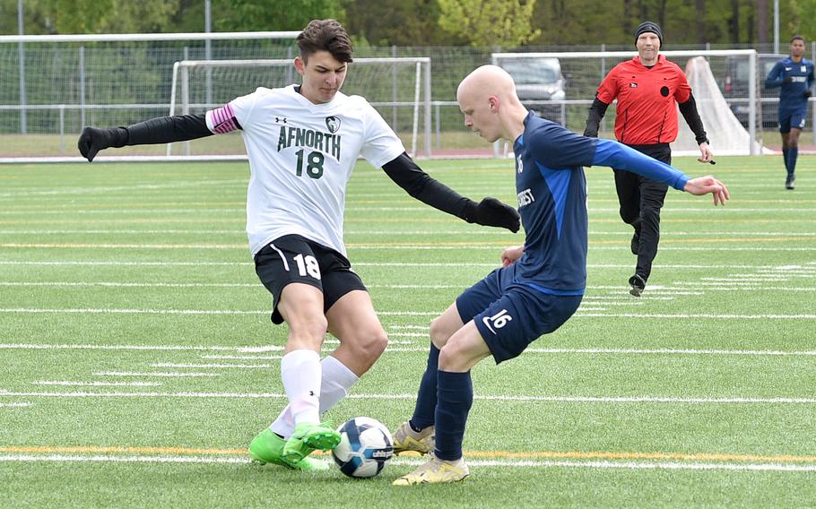 AFNORTH center back Nathan Goldsmith and Black Forest Academy striker Isaac Hinkle go for a ball during a match on April 20, 2024, at Ramstein High School on Ramstein Air Base, Germany.
