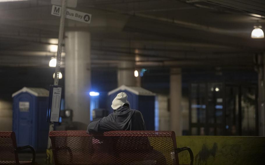 A man sits at a bus bay in Bethesda, Md. Homelessness rose across the D.C. region over the last year, with the greatest increases in the suburbs, according to the Metropolitan Washington Council of Governments. Montgomery County reported 894 people experiencing sheltered or unsheltered homelessness in 2023, up from 581 the previous year.