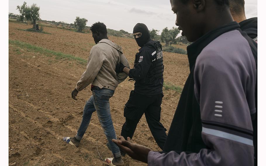 Agents from the Tunisian National Guard in Sfax, Tunisia, on June 1, 2023, arrest migrants who had been waiting in a safe house to board a boat to Italy. 