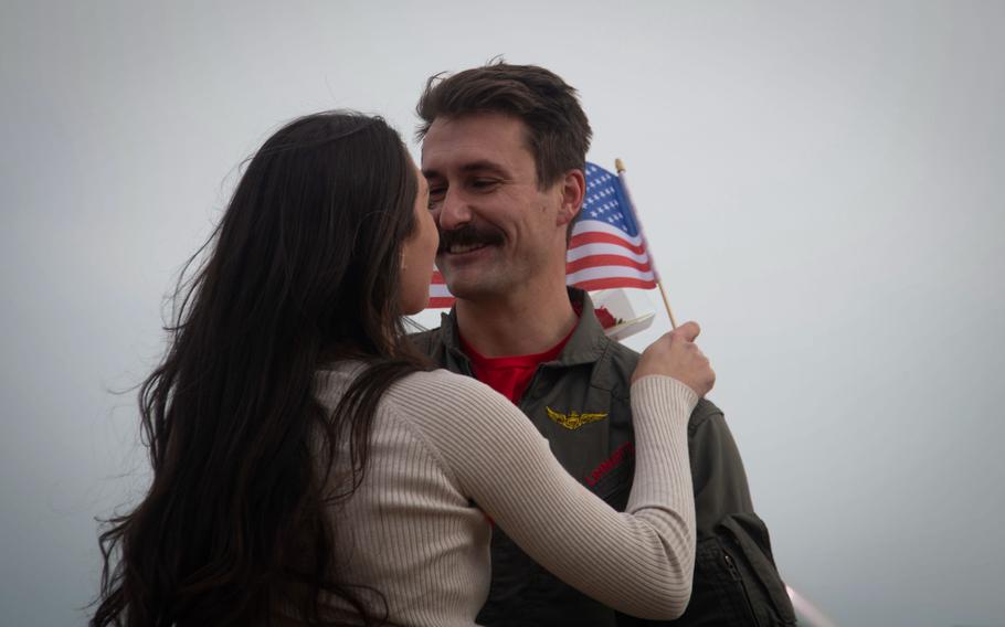 An aviator assigned to Strike Fighter Squadron (VFA) 87, “Golden Warriors,” reunites with his wife after their homecoming flight to Naval Air Station Oceana, Jan. 15, 2024.