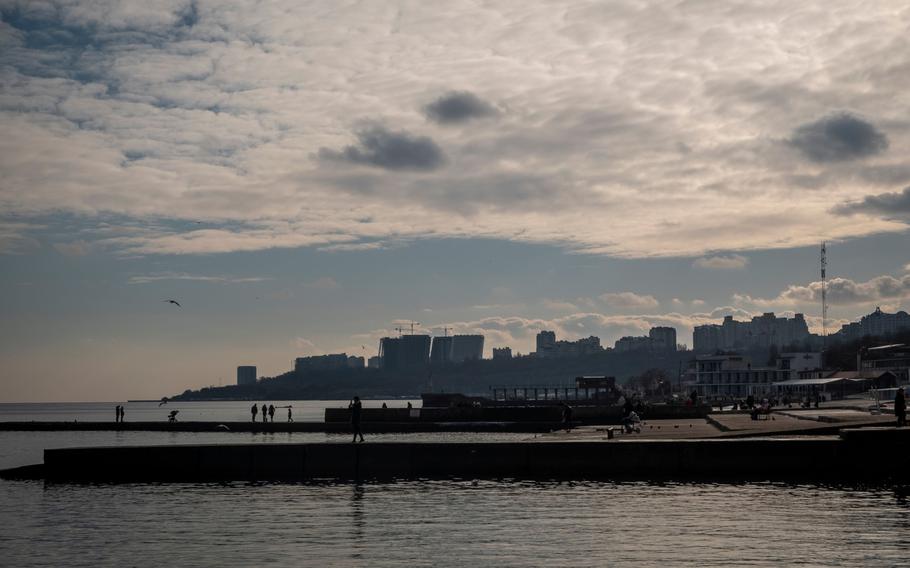 Visitors at a pier on the Black Sea coast in Odessa, Ukraine, on Jan. 22, 2022. MUST CREDIT: Bloomberg photo by Christopher Occhicone.