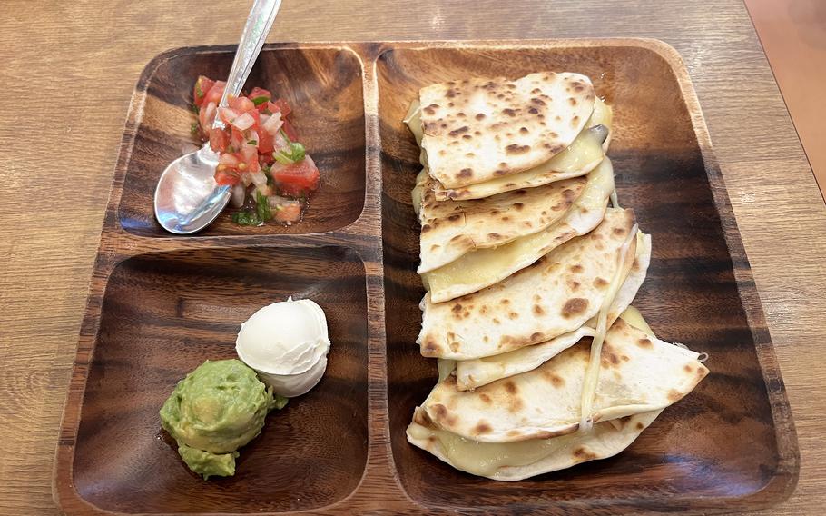 The cheese-and-mushroom quesadilla from Chiles Mexican Grill in Harajuku, Tokyo, is served with a side of salsa, guacamole and sour cream.