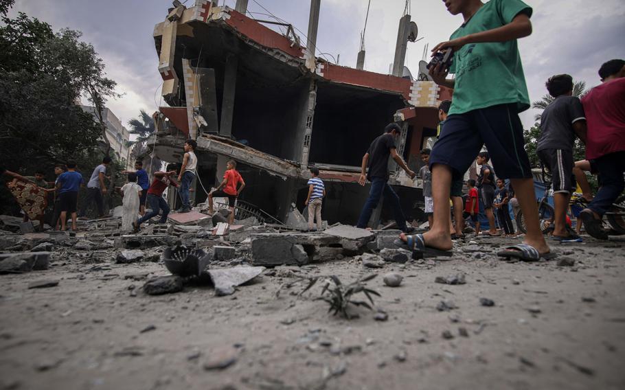 Blast rubble on the road beside a destroyed building following Israeli airstrikes overnight in Khan Younis, southern Gaza, on Oct. 9, 2023.