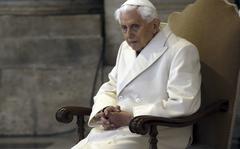FILE - Pope Emeritus Benedict XVI sits in St. Peter's Basilica as he attends the ceremony marking the start of the Holy Year, at the Vatican, Dec. 8, 2015. A long-awaited report on the church's handling of cases of sexual abuse by clergy and others in Germany's Munich archdiocese and which was once led by retired Pope Benedict XVI from 1977 until 1982, is being released on Thursday Jan. 20, 2022. (AP Photo/Gregorio Borgia, File)