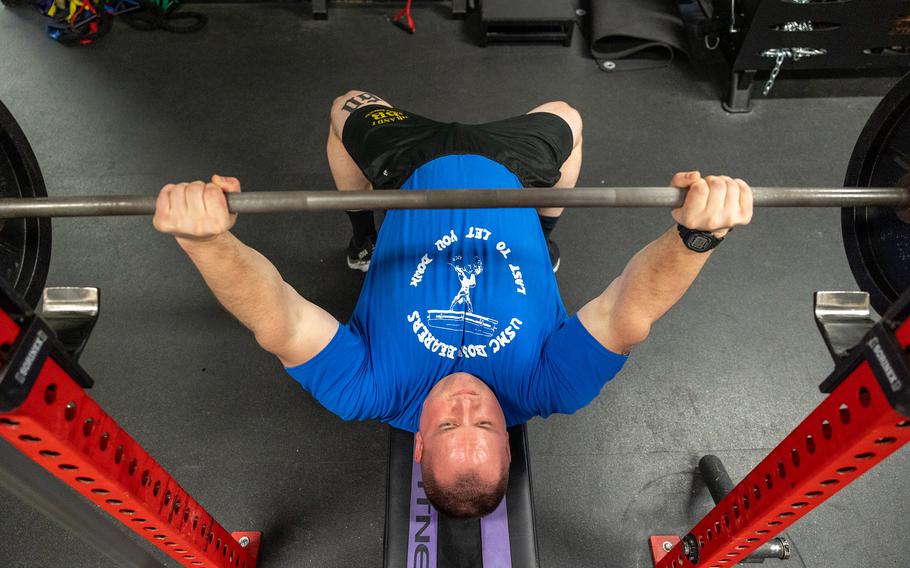 A Marine bench presses