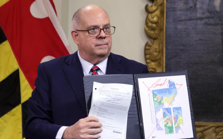 Maryland’s Republican Gov. Larry Hogan on Dec. 9, 2021, in Annapolis, Md., shows a copy of the redrawn congressional map approved by the General Assembly that is crossed out in red, during a briefing in which he announced his veto of the plan, A Maryland judge ruled Friday, March 25, 2022, that the state’s new congressional map is unconstitutional.