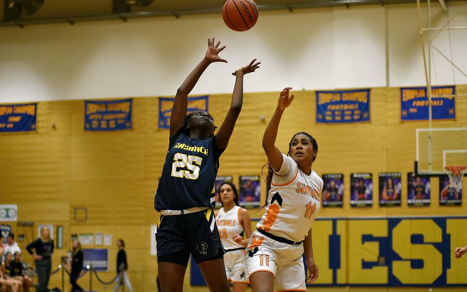 Ansbach sophomore Lizzy Agudzi-Addo goes up for a ball with Spangdahlem senior Gabrielle Schmidt in the background during a Division III semifinal at the DODEA European Basketball Championships on Feb. 16, 2024, at Wiesbaden High School in Wiesbaden, Germany.