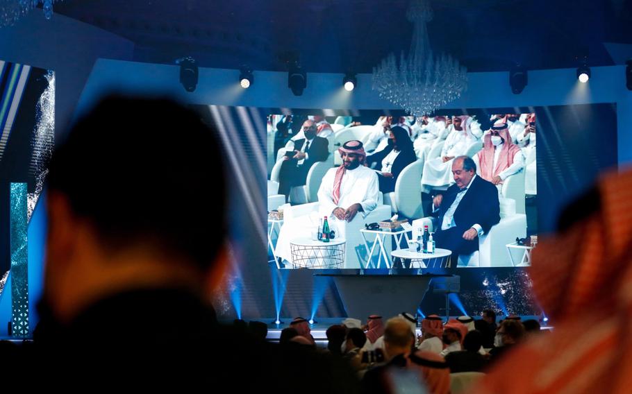 Mohammed bin Salman, Saudi Arabia’s crown prince, left, attends the Future Investment Initiative (FII) conference in Riyadh, Saudi Arabia, on Oct. 26, 2021. 