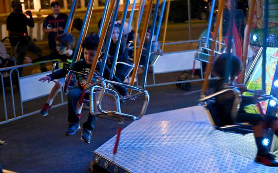 221022-N-OX321-1084 NAVAL AIR STATION SIGONELLA, Italy (Oct. 22, 2022) Children ride the kiddie swings in the carnival ride area during Naval Air Station Sigonella’s 2022 Autumn Fest, Oct. 22, 2022. Autumn Fest is an annual event that allows NAS Sigonella personnel to sponsor locals onto the installation to celebrate with base personnel. NAS Sigonella’s strategic location enables U.S., allied, and partner nation forces to deploy and respond as required, ensuring security and stability in Europe, Africa, and Central Command. (U.S. Navy photo by Mass Communication Specialist 1st Class Kegan E. Kay)