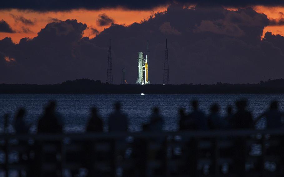 The Space Launch System rocket sits on the launch pad at NASA’s Kennedy Space Center Launch Complex 39B as spectators wait across the water at Rotary Riverfront Park in Titusville, hoping to see NASA’s Artemis I mission launch.