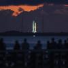 The Space Launch System rocket sits on the launch pad at NASAâ€™s Kennedy Space Center Launch Complex 39B as spectators wait across the water at Rotary Riverfront Park in Titusville, hoping to see NASA&apos;s Artemis I mission launch.
