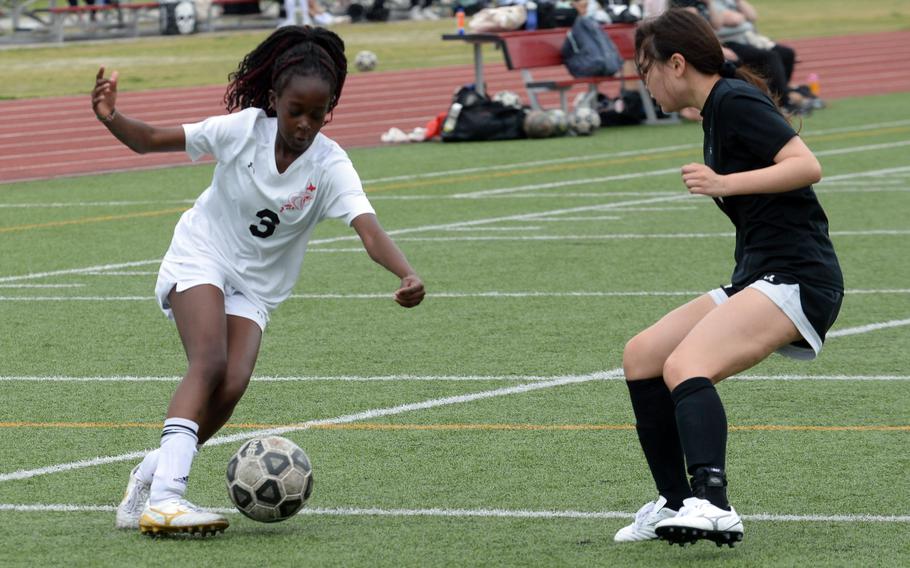 E.J. King’s Tiffany Nabutete plays the ball against Zama’s Sarah Larm during Saturday’s DODEA-Japan girls soccer match. The Cobras won 4-0.