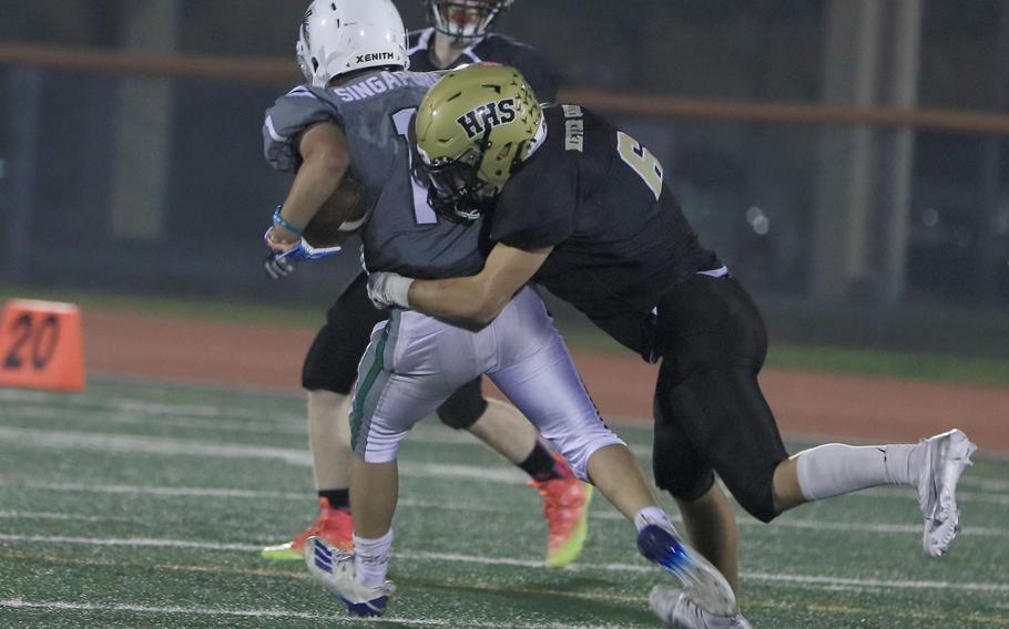 Humphreys' Ayden Watts puts the collar on Singapore ball carrier Quentin Chong.