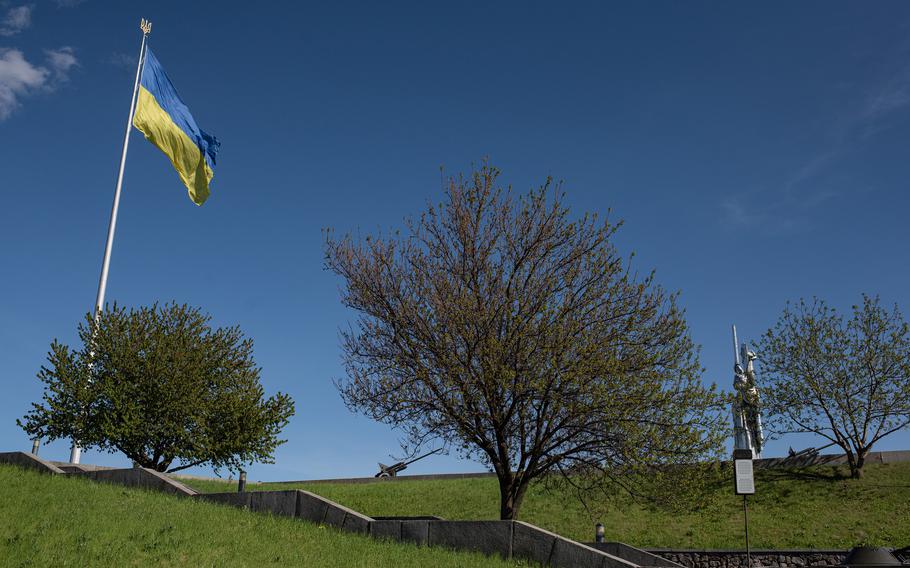A giant Ukrainian national flag is seen next to the “Mother Motherland” monument, on May 9, 2022 in Kyiv, Ukraine.