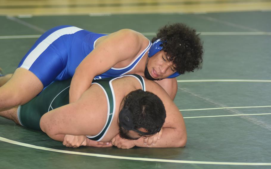 Rota's Colin Clark, top, and Naples' Joaquin Tun-Rauser compete in the opening rounds of the DODEA Southern European Finals on Saturday, March 5, 2022 at Naples Middle High School. Clark pinned Tun-Rauser to win the match. 