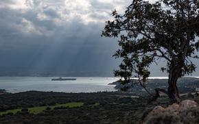 A ship sails into a bay.