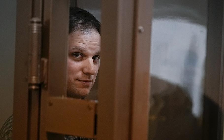 Wall Street Journal reporter Evan Gershkovich stands in a glass cage in a courtroom in Moscow, Russia, on April 18, 2023. 