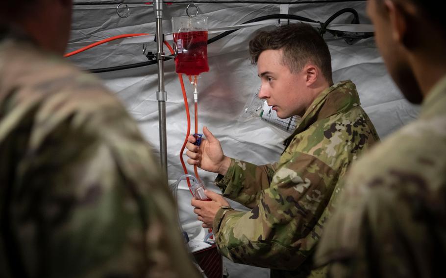 Private 1st Class Walker Bobo tests equipment during a hospital exercise at Baumholder Army Airfield, Germany, on May 17, 2024. The exercise was part of Defender 24, a series of field training and live-fire exercise in Europe that began in February and has included tens of thousands of American and allied troops.