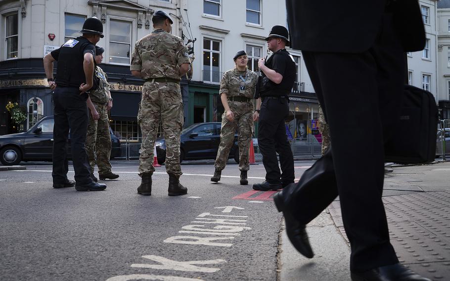 Police and military personnel patrol near Buckingham Palace on Sept. 15, 2022.