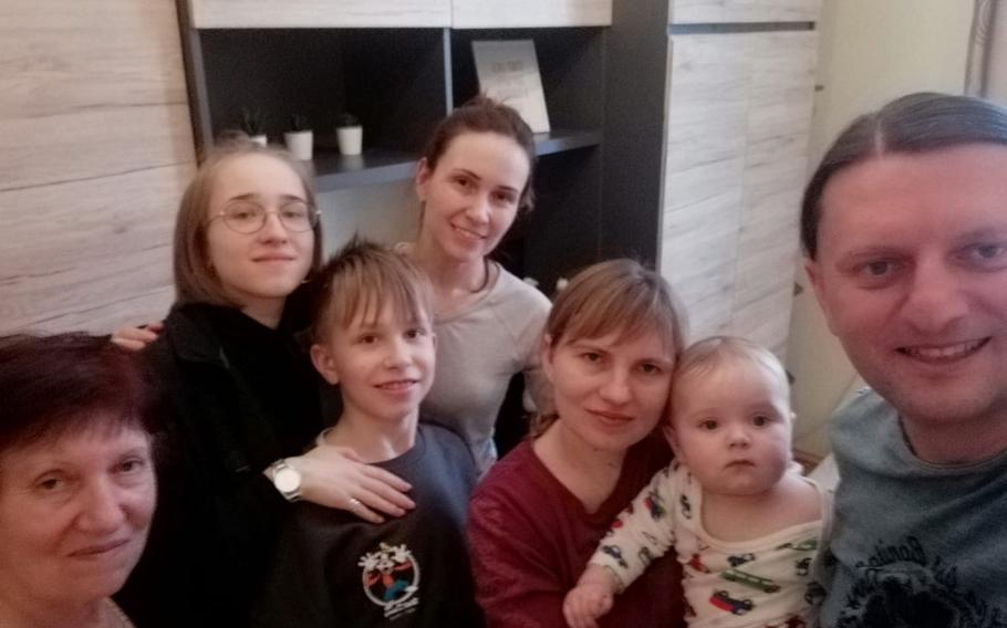 Jaroslaw Olak, right, poses for a photo with Ukrainian refugees from Kyiv and Zaporizhzhia in Warsaw in March. From left are Liubov, Olesia, Andrii, Natalia and Kateryna, holding her infant son, Nazar.