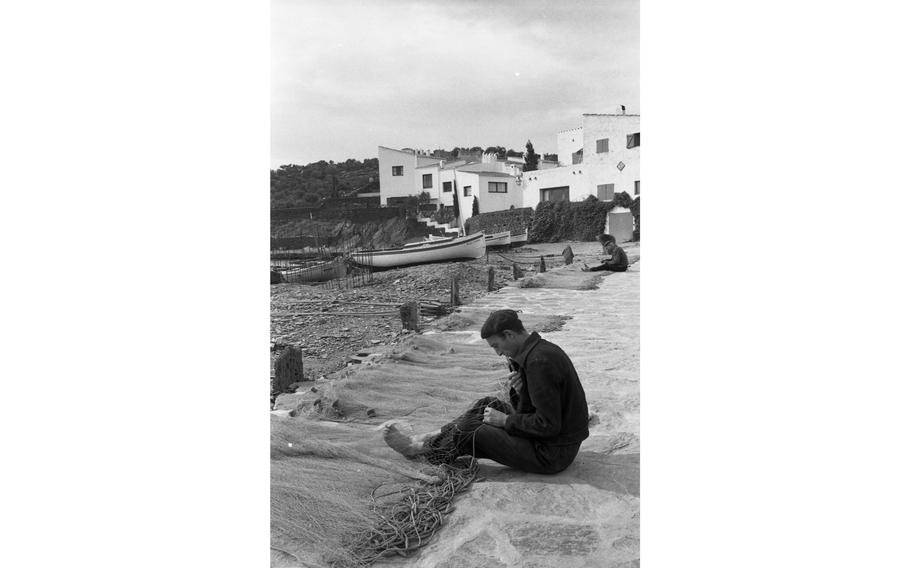 Fishermen mend their nets in front of the home of surrealist artist Salvador Dali. The small fishing village of  Port Lligat on the Spanish Costa Brava along the Mediterranean coast has been the primary home of Dali and his wife and muse Gala since 1930.