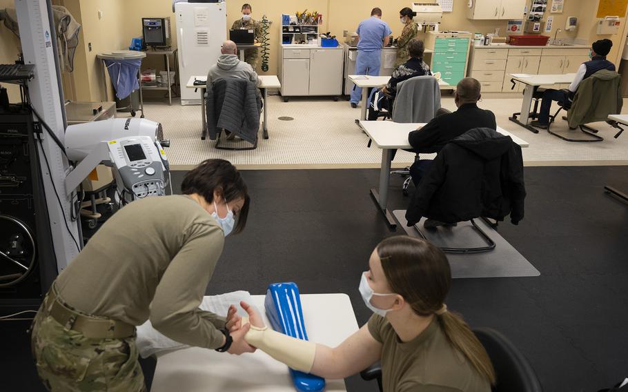 Capt. Emily Philips, 88th Operational Medical Readiness Squadron occupational therapist, demonstrates splinting a hand Jan. 25, 2022, on Airman 1st Class Leah Fitzke in Wright-Patterson Medical Center.