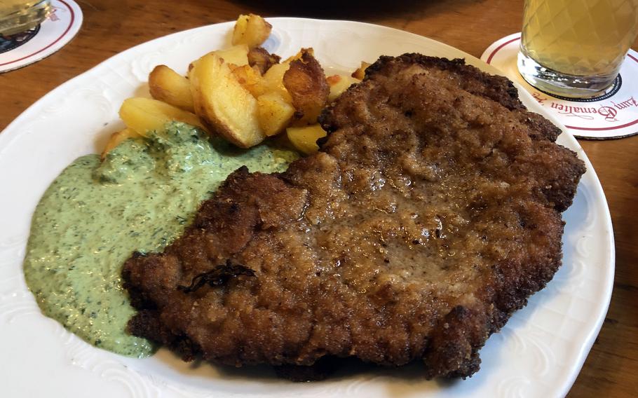A veal Frankfurter schnitzel with Frankfurter Gruene Sosse (green sauce) and fried potatoes as served at Zum Gemalten Haus, the popular apple wine tavern in Frankfurts Sachsenhausen district. 