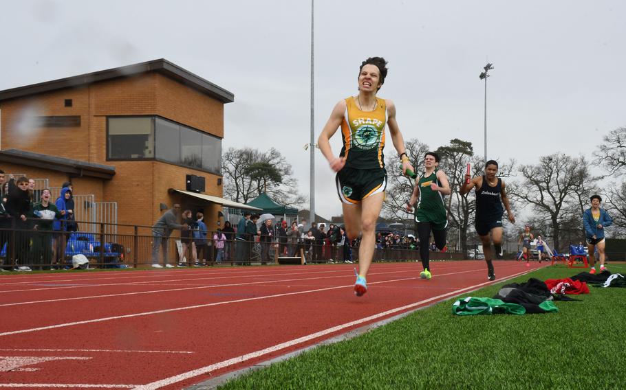 SHAPE's Tudor Varvari crosses the finish line during the sprint medley relay ahead of Alconbury's Jonathen Reyes and Lakenheath's Brian Miles on Saturday, March 18, 2023 at RAF Lakenheath High School. The Spartans won four out of the eight relay events during the 2023 season opener. 