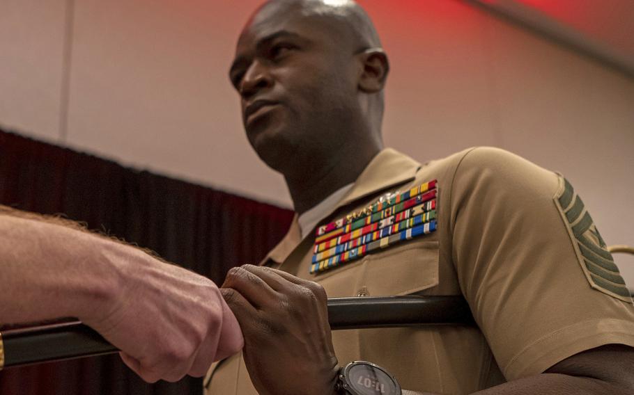 Marine Corps Sgt. Maj. Delwin Ellington, seen here receiving the noncommissioned officer sword during a ceremony in Tampa, Fla., on July 8, 2022, making him the top NCO of Marine Forces Central Command. Ellington was relieved of his duties Feb. 22, 2023, according to the Marines. 