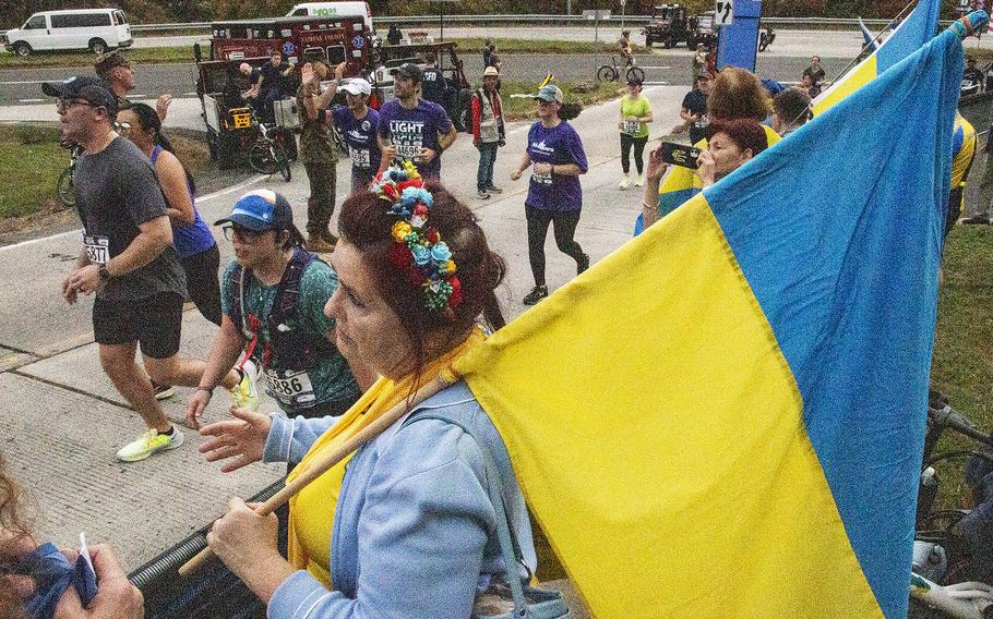 Spectators carry Ukrainian flags near the finish of the 48th Marine Corps Marathon on Sunday, Oct. 29, 2023, in Arlington, Va.