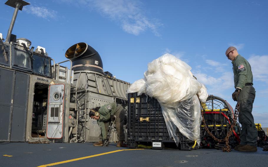Sailors assigned to Assault Craft Unit 4 prepare material recovered in the Atlantic Ocean from the Chinese spy balloon on Feb. 10, 2023, for transport to federal agents at Joint Expeditionary Base Little Creek, Virginia Beach, Va. 