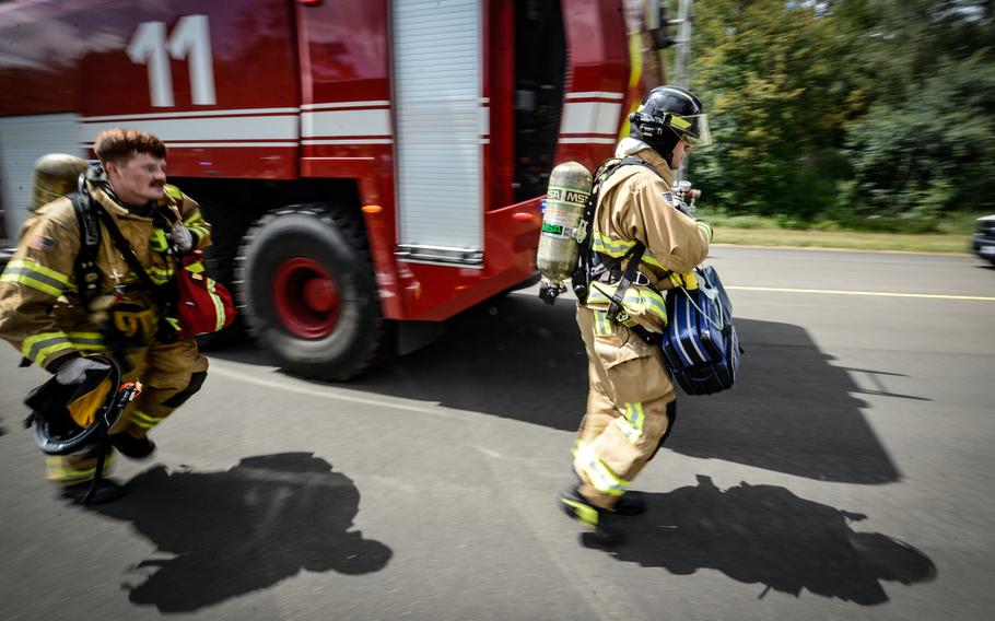 Firefighters assigned to the 86th Civil Engineer Group respond to a real medical emergency call involving an unconscious base employee at Ramstein Air Base, Germany, July 26, 2022. The first responders answered the emergency call in the midst of an ongoing simulated aircraft crash exercise scenario.
