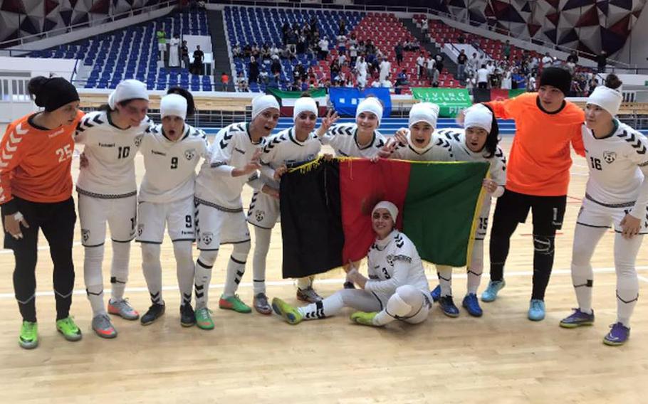 The Afghan national women's soccer team pose for a photo during a tournament in November 2019. Eighty-six players, officials and family members were evacuated from Afghanistan to Australia.