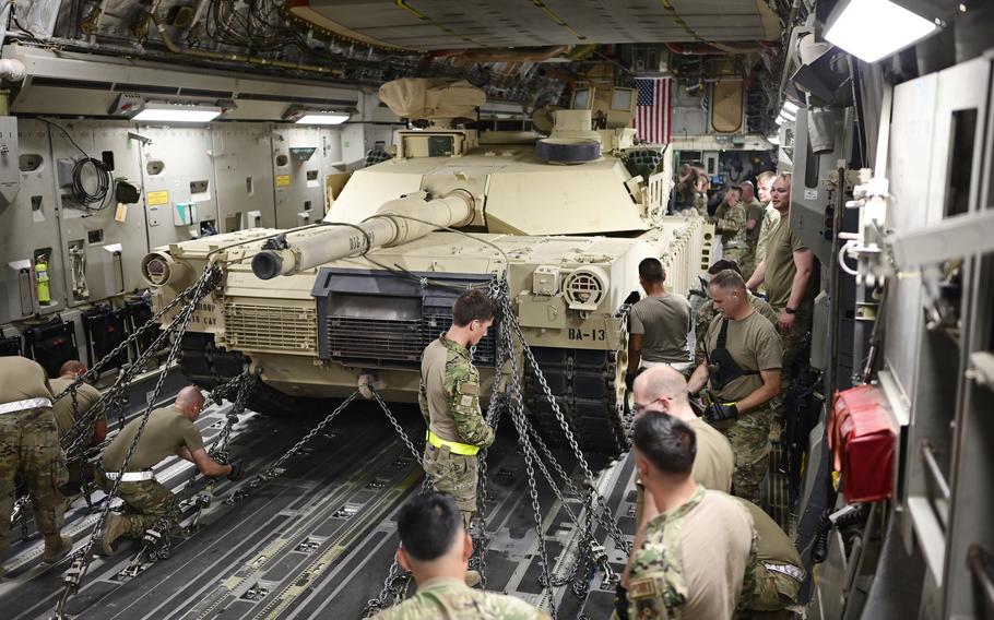 Airmen assigned to the 386th Air Expeditionary Wing load an M1A2 Abrams tank a plane assigned to the 816th Expeditionary Airlift Squadron at Ali Al Salem Air Base, Kuwait, Aug. 27, 2022.