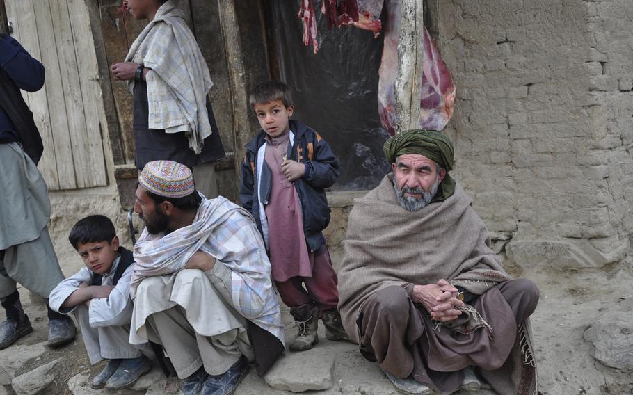 Villagers in Khanjankhel look skeptically at U.S. and Afghan soldiers who swept into the village in response to reports of Taliban intimidation and kidnappings. 